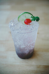 Fruit juice mixed with soda in glass on food table in the restaurant