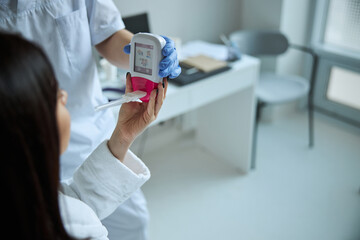 Patient receiving a spirometer from the physician hands © Svitlana