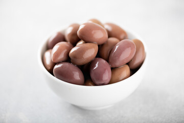 kalamata olives in white bowl on white background