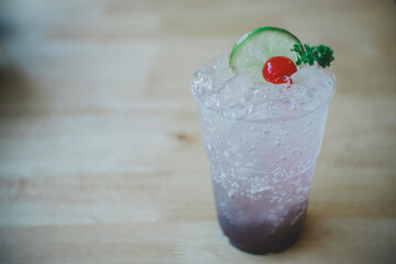 Fruit juice mixed with soda in glass on food table in the restaurant