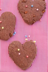 Valentine's day cookies. Chocolate heart shaped cookies with sprinkles. Flat lay