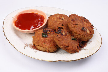 Tuna fish meat patty burger kebab with sauce on pate over white background