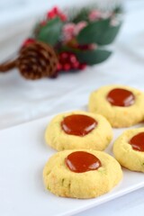 Thumbprint cookies on white background with Christmas decoration
