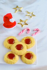 Thumbprint cookies on white background with Christmas decoration

