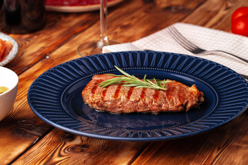 Grilled beef steak served on blue plate