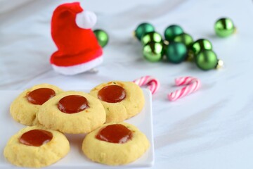 Thumbprint cookies on white background with Christmas decoration
