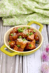 Diced tofu with soy sauce, sesame seed and chives.