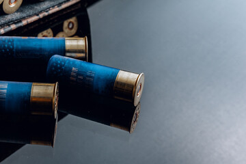 Rifle bullets or cartridges on black shiny background