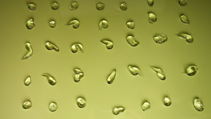 Clear gel drops. Hand sanitizer, alcohol gel blobs on pastel green background. Virus protection