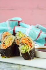 Homemade Sushi with carrot and avocado served with soy sauce and wasabi
