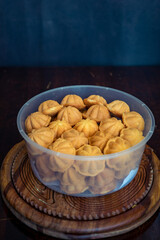 Kuih Bahulu, baulu or bolu in a container. Sponge cake baked in special aluminium moulds is the Asian tradition food in popular Malaysia and Indonesia.