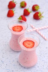 Strawberry smoothie in glass on white background