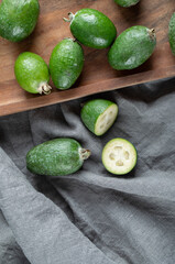 A wooden cutting board with fresh feijoa