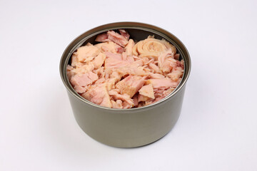 Tuna fish meat flaky chunk in tin can on white background
