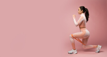 Website header of Sporty young woman doing exercise with resistance band