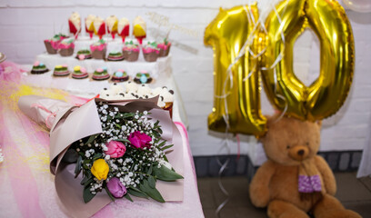bouquet and sweets on the table for the birthday of a ten year old girl