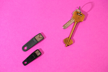 Home Concepts. Bunch of Traditional Metal House Keys Against Pair of Electronic Chip Keys  Together Over Colorful Background.