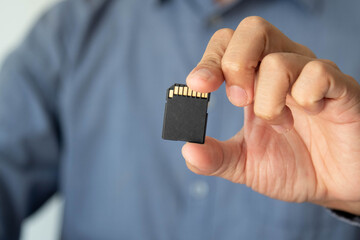 Business concept. Businessman holding SD card,memory card. Copy space