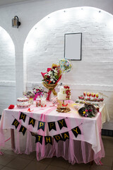 birthday cake and various sweets on the table