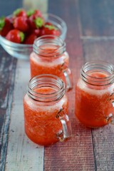 Fototapeta na wymiar Fresh organic strawberry juice in glass jar