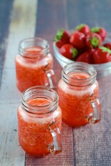 Fototapeta na wymiar Fresh organic strawberry juice in glass jar