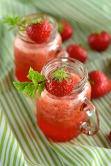 Fresh organic strawberry juice with mint in glass jar