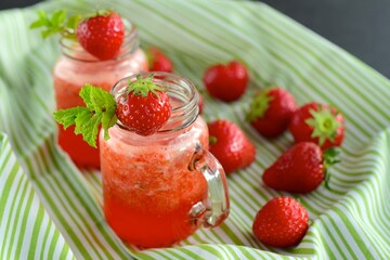 Fresh organic strawberry juice with mint in glass jar
