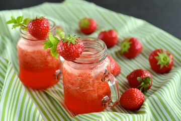 Fresh organic strawberry juice with mint in glass jar
