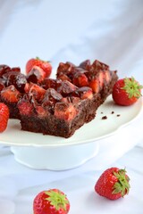 Strawberry chocolate brownies with fresh strawberry and chocolate sauce