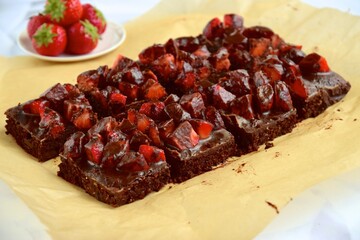 Strawberry chocolate brownies with fresh strawberry and chocolate sauce