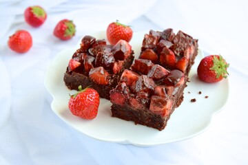 Strawberry chocolate brownies with fresh strawberry and chocolate sauce