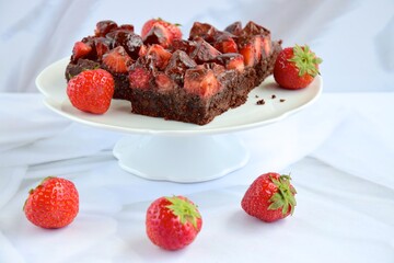 Strawberry chocolate brownies with fresh strawberry and chocolate sauce