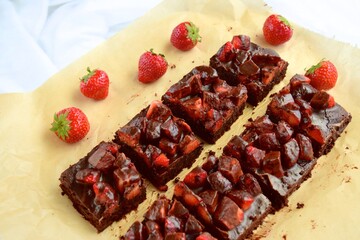 Strawberry chocolate brownies with fresh strawberry and chocolate sauce