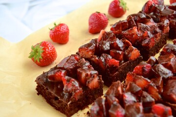 Strawberry chocolate brownies with fresh strawberry and chocolate sauce