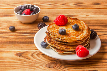 Pancakes And Berries On Wooden Background