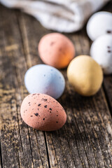 Colorful chocolate easter eggs. Sweet candy eggs on wooden table.