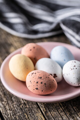 Colorful chocolate easter eggs. Sweet candy eggs on wooden table.