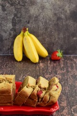 Strawberry banana yogurt cake with fresh strawberry and banana on rustic background