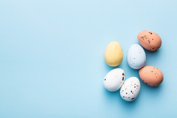 Colorful chocolate easter eggs. Sweet candy eggs on blue background.