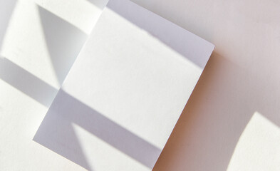 Blank notepad page layout with white sheets and geometric pattern shadow overlay effect