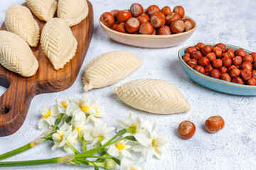Traditional Azerbaijan holiday Novruz cookies baklava on the light  background with nuts and shekerbura,qogal,mutaki,flat lay,top view,space for copy