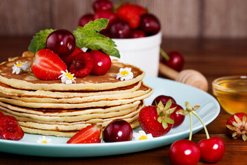 homemade pancakes with berries and mint and honey