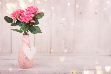 Flowers composition for Valentine's, Mother's or Women's Day. Pink flowers on old white wooden background. Still-life.