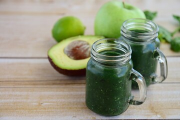 Green smoothie with spirulina, spinach, avocado and apple