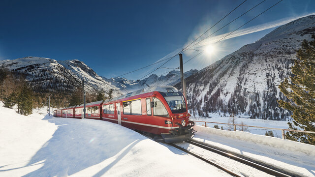 Bernina Express Red Train between the Ice of Piz Pal&ugrave; and Bernina