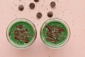 Obraz na płótnie Canvas Spirulina mint smoothie with chocolate and chia seeds. Top view