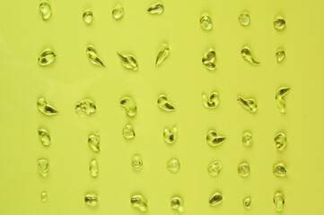 Clear gel drops. Hand sanitizer, alcohol gel blobs on yellow background. Virus protection