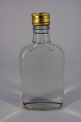 Classic glass bottle of 500 ml with swelling neck and gilded lid for alcoholic and strong drinks...