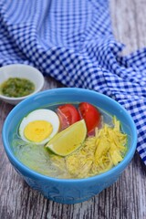 Soto Ayam, traditional Indonesian soup made from broth, chicken, egg, vermicelli and vegetables.