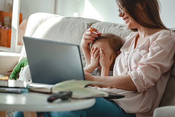 Concept work at home and home family education, mother working with son multitasking